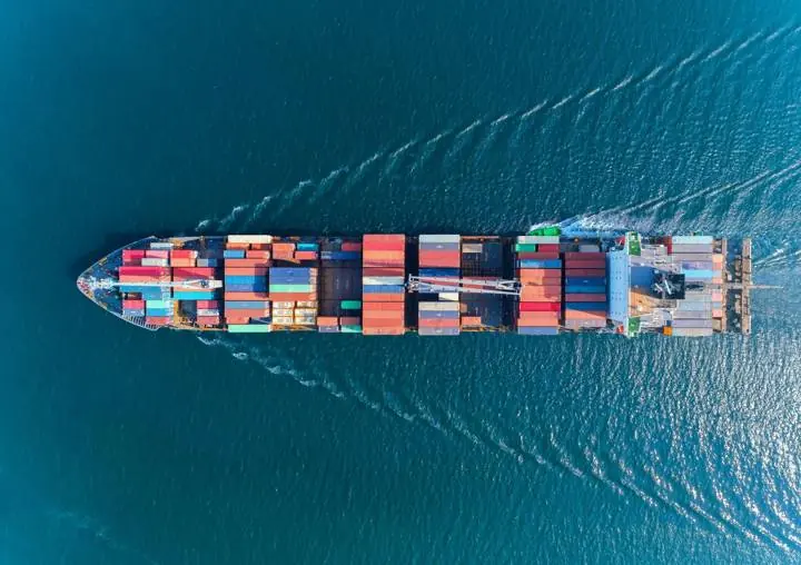 Aerial view of a loaded container ship at sea